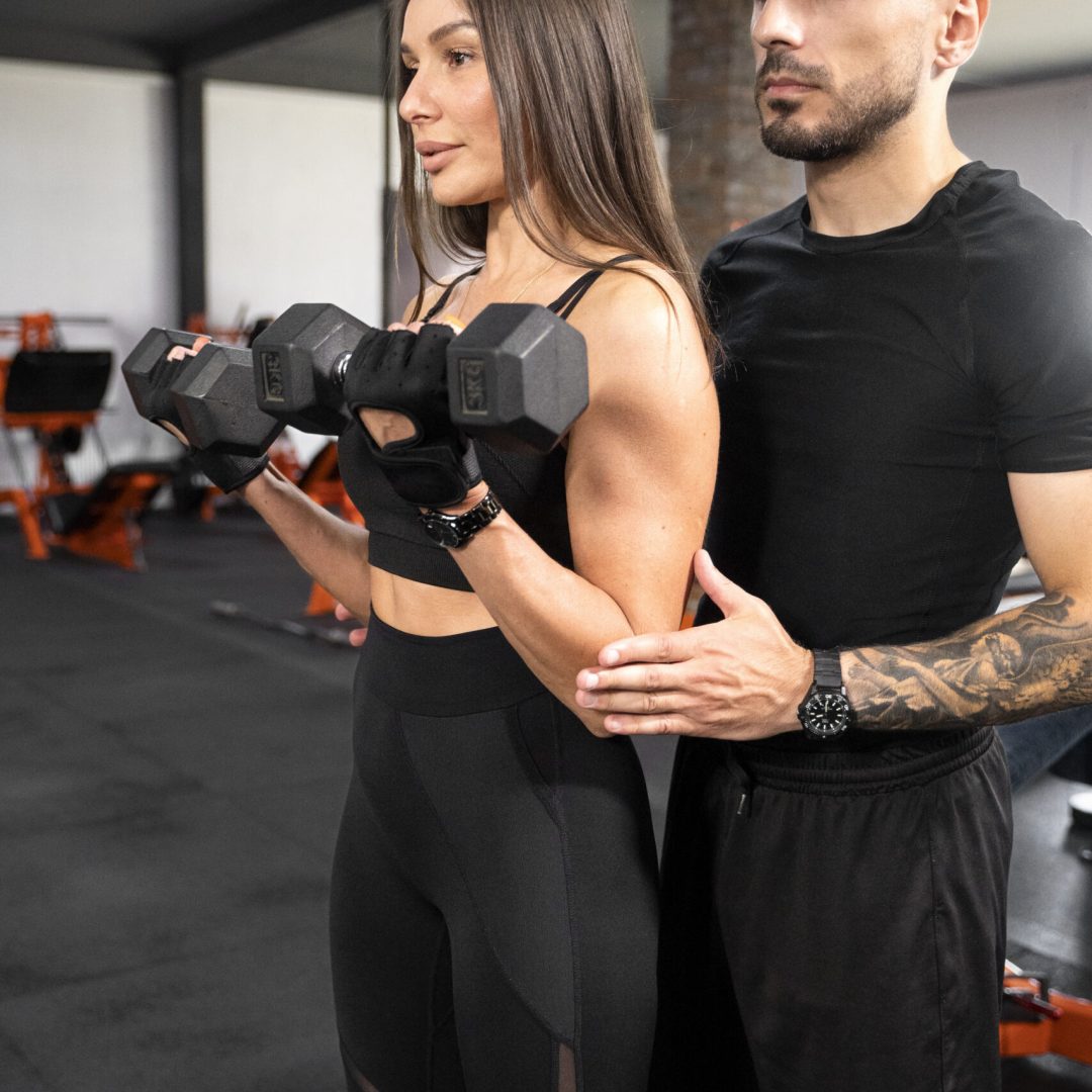 woman-working-out-with-dumbbells-medium-shot